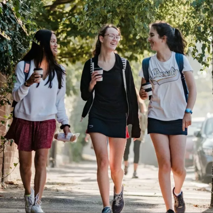 3 sixth form students at nhehs walking to school along the road